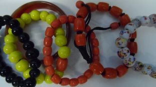 FIVE PEKING GLASS BRACELETS - AMBER, YELLOW, BLACK AND WHITE  ( 5 )