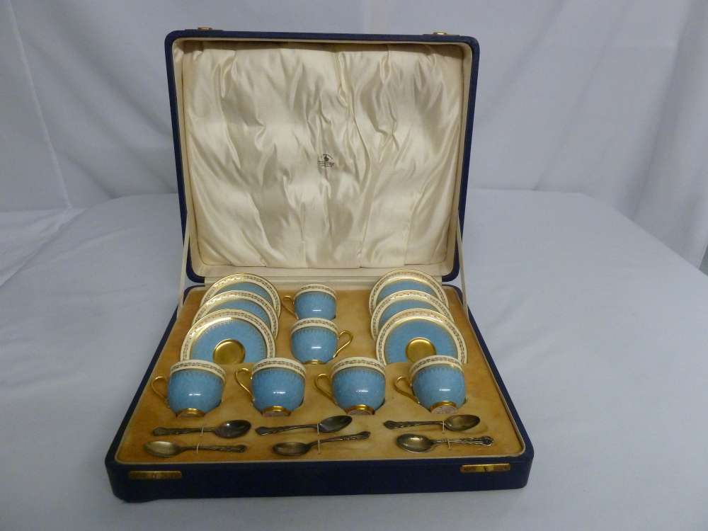 A cased set of Royal Worcester coffee cups and saucers and six silver coffee spoons