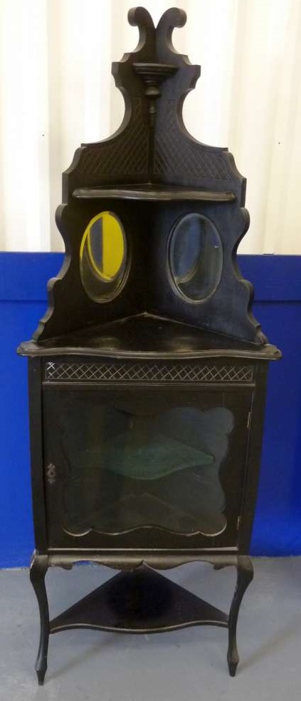 Ebonised corner display cabinet with glazed hinged door on three cabriole legs