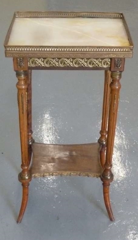 A late 19th century French occasional table with marble top and pierced brass gallery on four