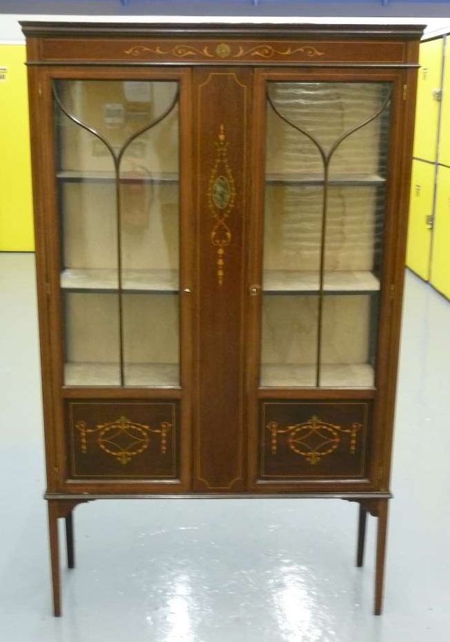 Edwardian glazed display case with decorative panels to front on four tapering legs