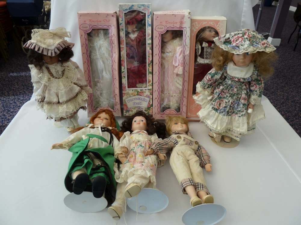 Nine porcelain dolls.