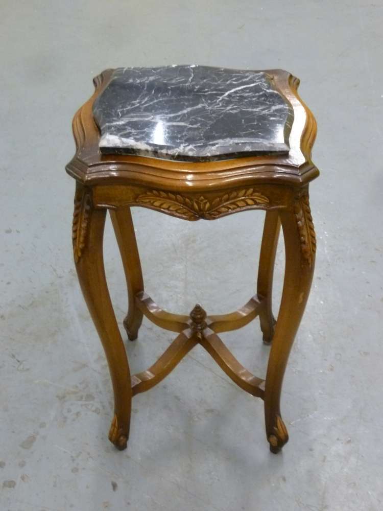 Mahogany side table on four cabriole legs with black marble top.