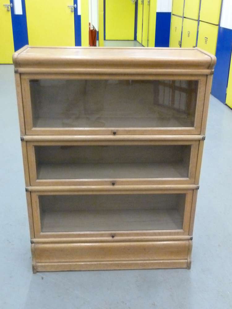 Globe Wernicke light oak three glazed sections on plinth base.