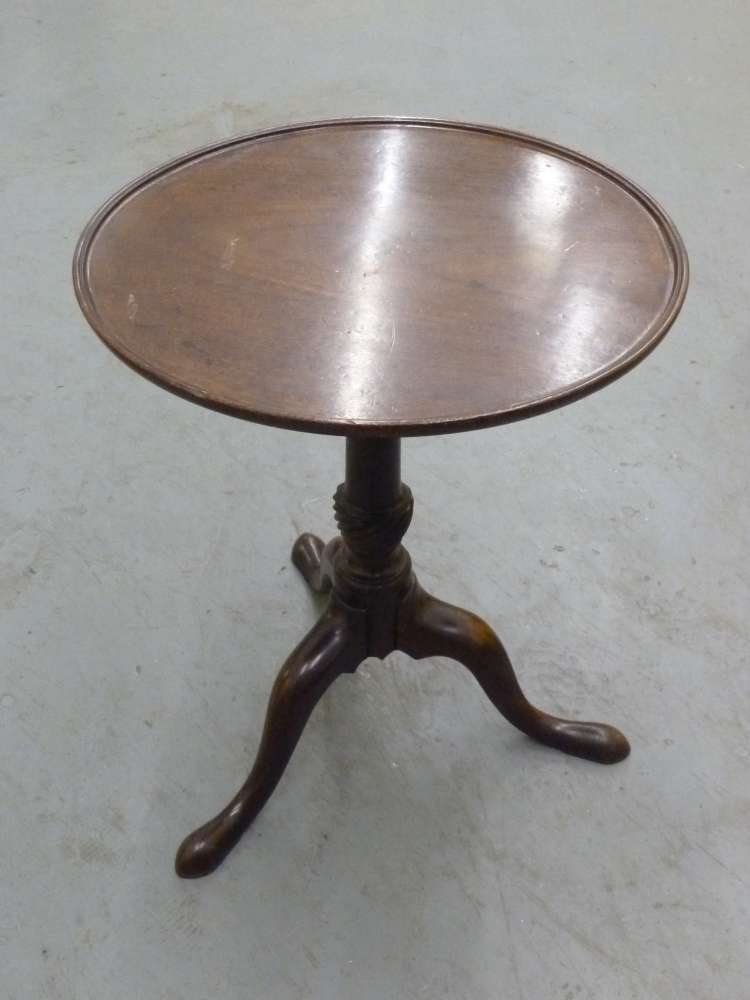 A Victorian mahogany tea table on tripod base.