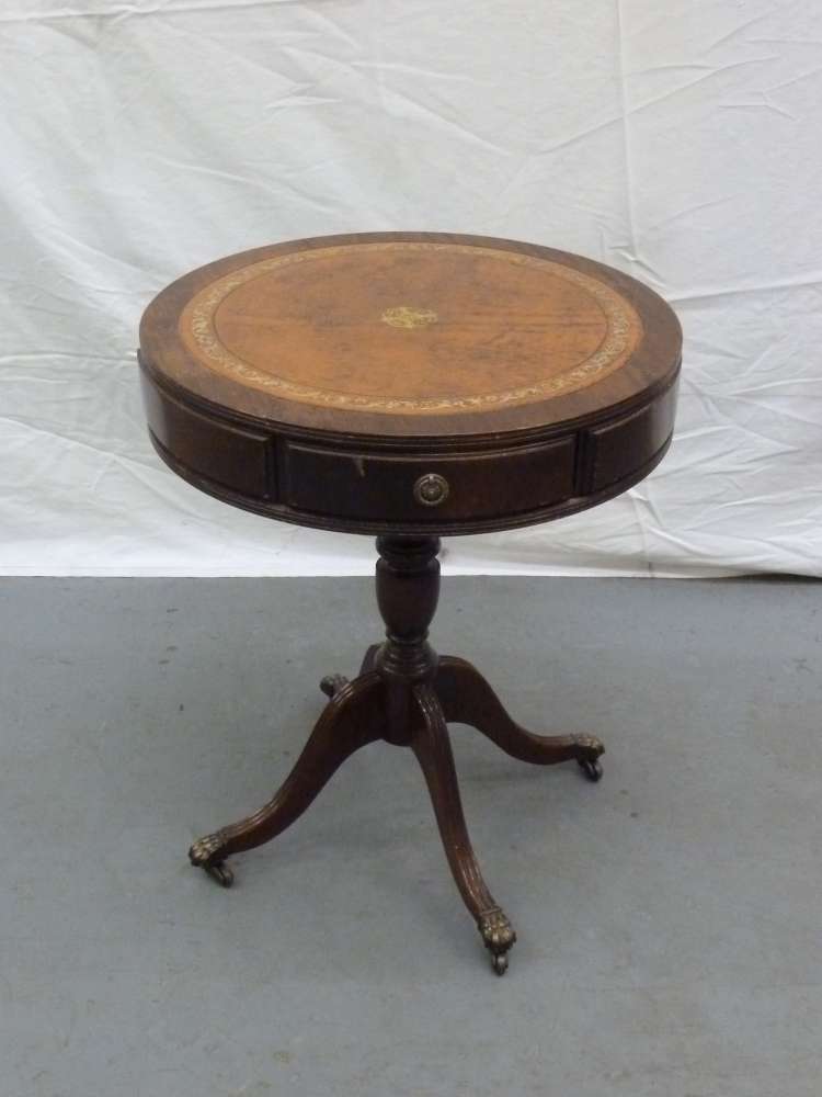 Mahogany reproduction drum table with three drawers, leather top on four outswept feet.