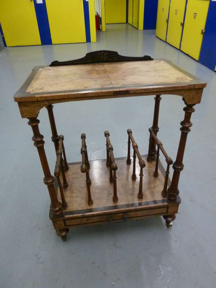 A Victorian walnut and ebony rectangular Canterbury with turned wooden pillars and legs on