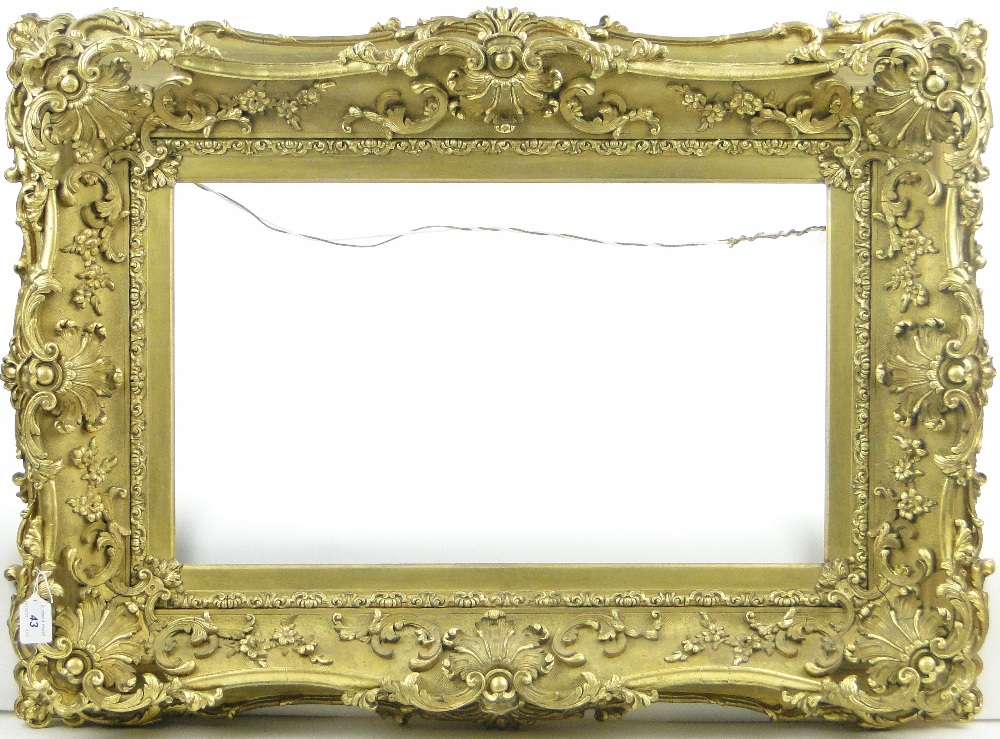 An ornate Victorian gilt gesso picture frame, inside measurements 14" x 24".