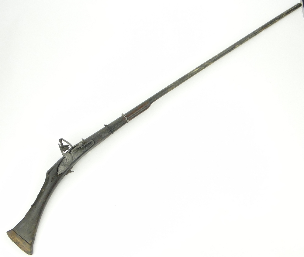 A Middle Eastern flintlock rifle with French lock plate, signed.