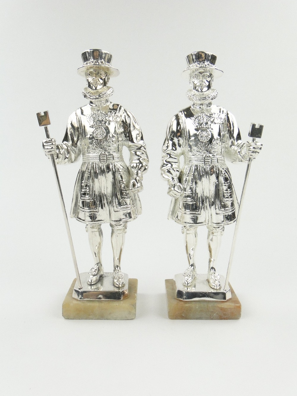 A pair of plated Yeoman of the Guard figures on alabaster plinths, 12.5".