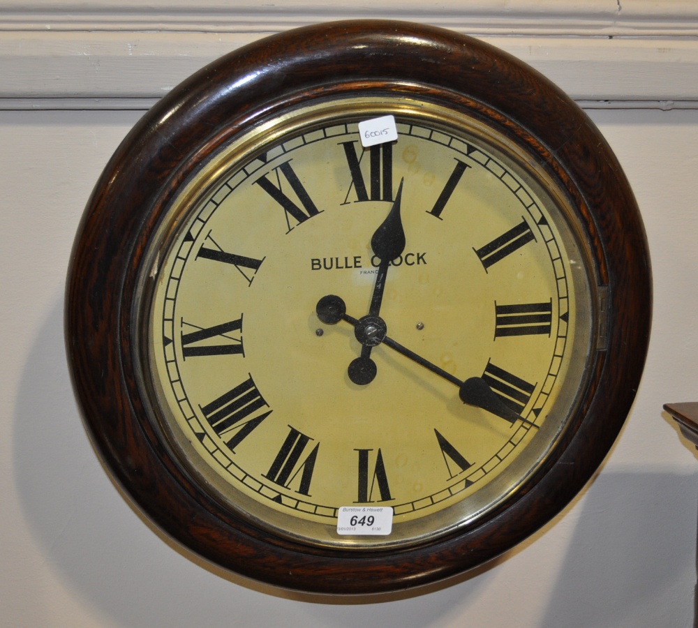 An oak framed Bulle electric dial wall clock.