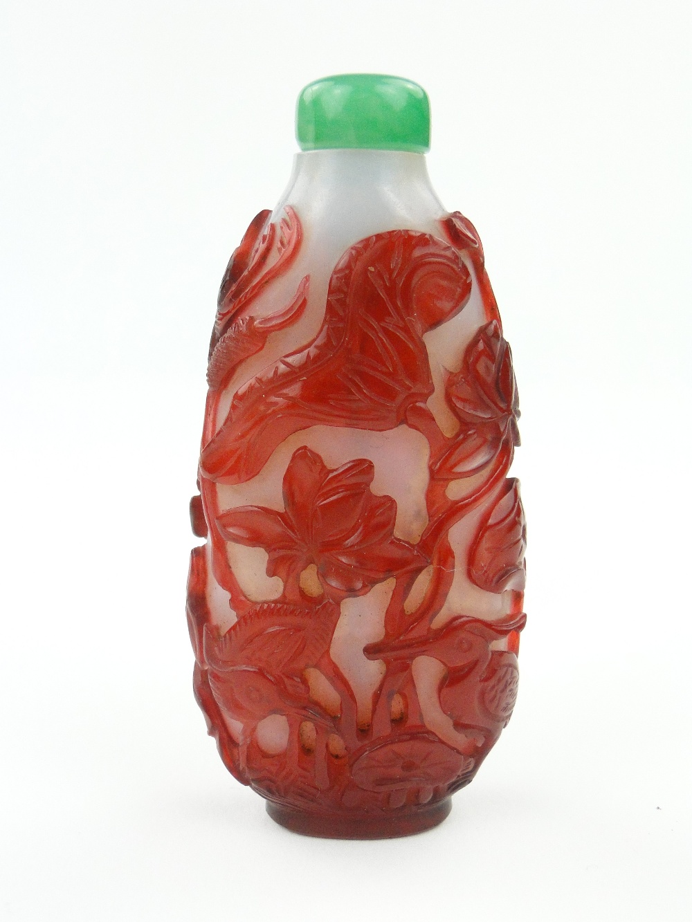 Antique Chinese Peking red overlay glass snuff bottle with design of birds amongst flowers, with
