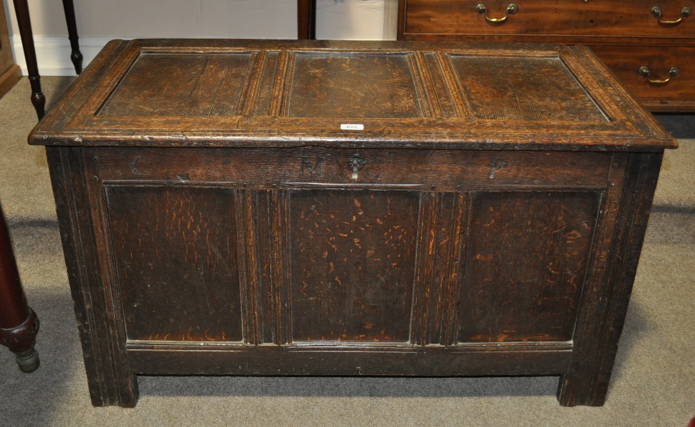A small 18th century joined oak coffer of panelled construction raised on stile legs, width 43".
