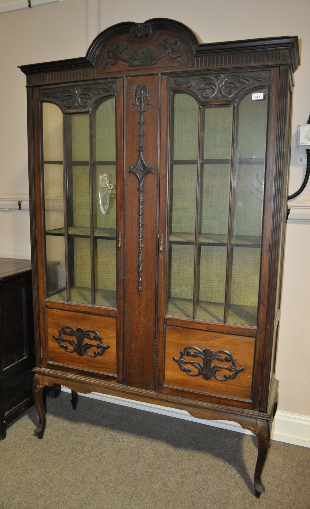 An Edwardian mahogany display cabinet having 2 lattice glazed and panelled doors with allover