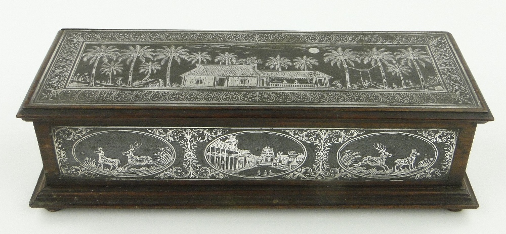 A Pitri box with silvered deer and house amongst palm trees, length 13".