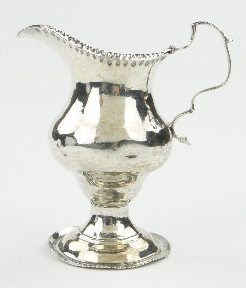 George III silver cream jug of bulbous form, makers marks TS London 1817, height 4".