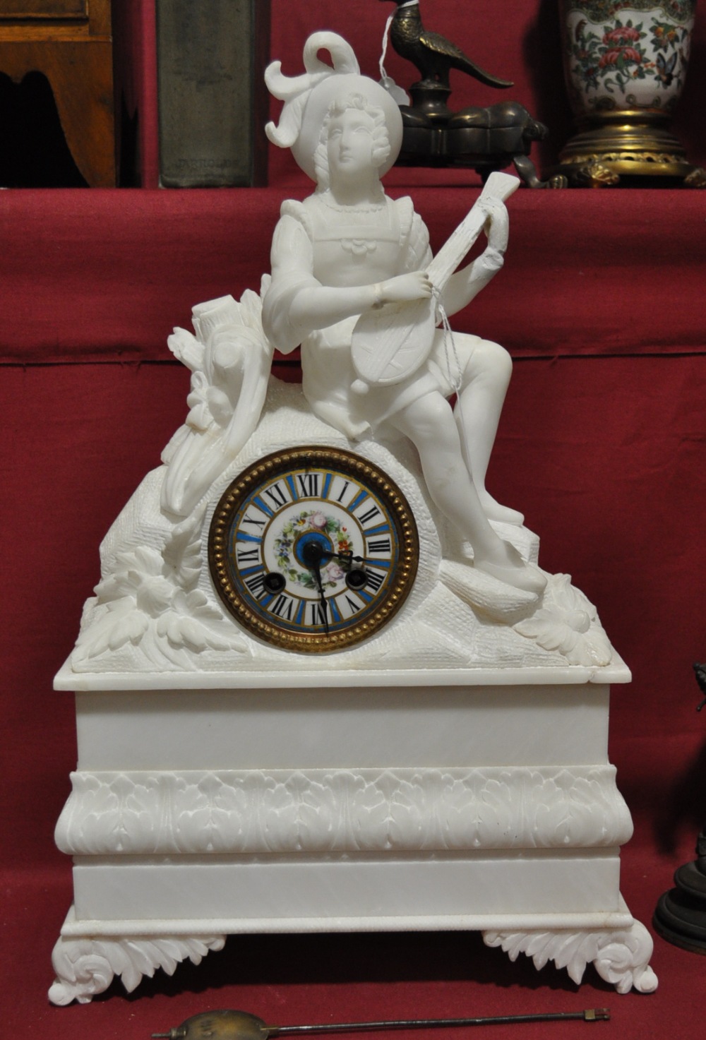A 19th century white alabaster cased mantle clock with 2-train striking movement, surmounted by a