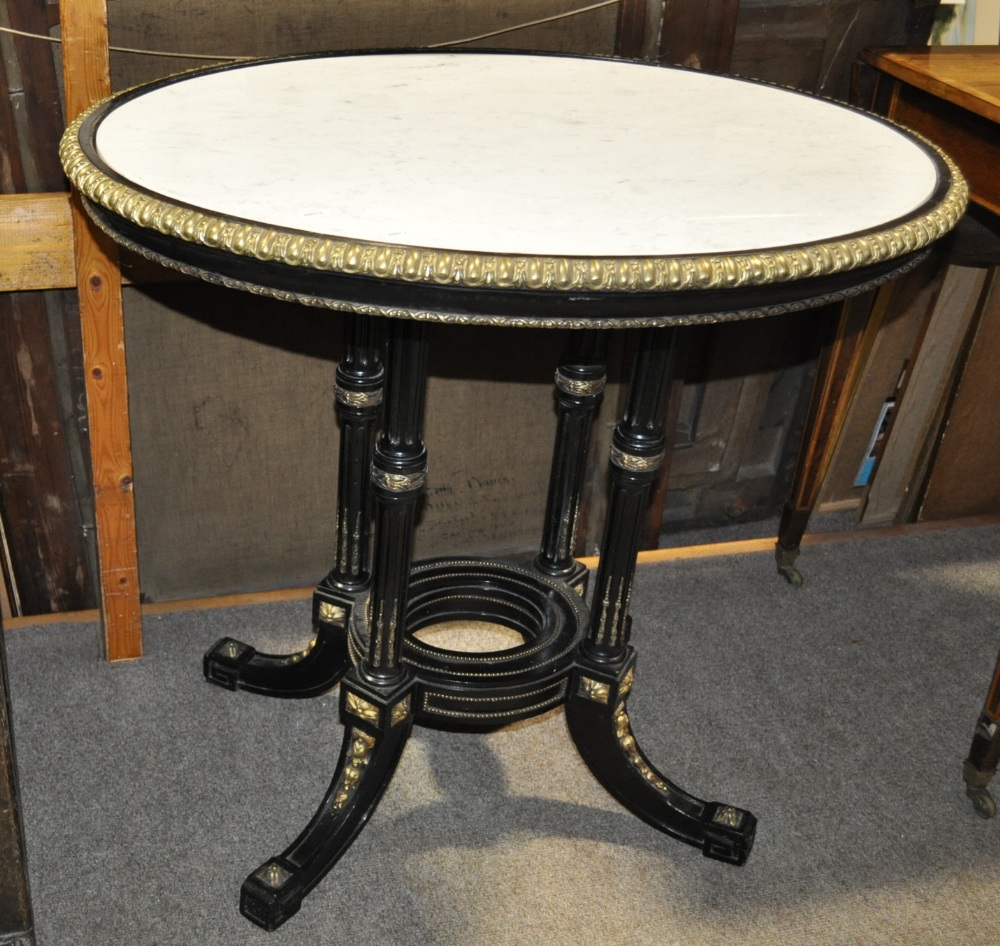 A 19th century ebonised centre table having a white and grey veined marble top with ormolu mounts,