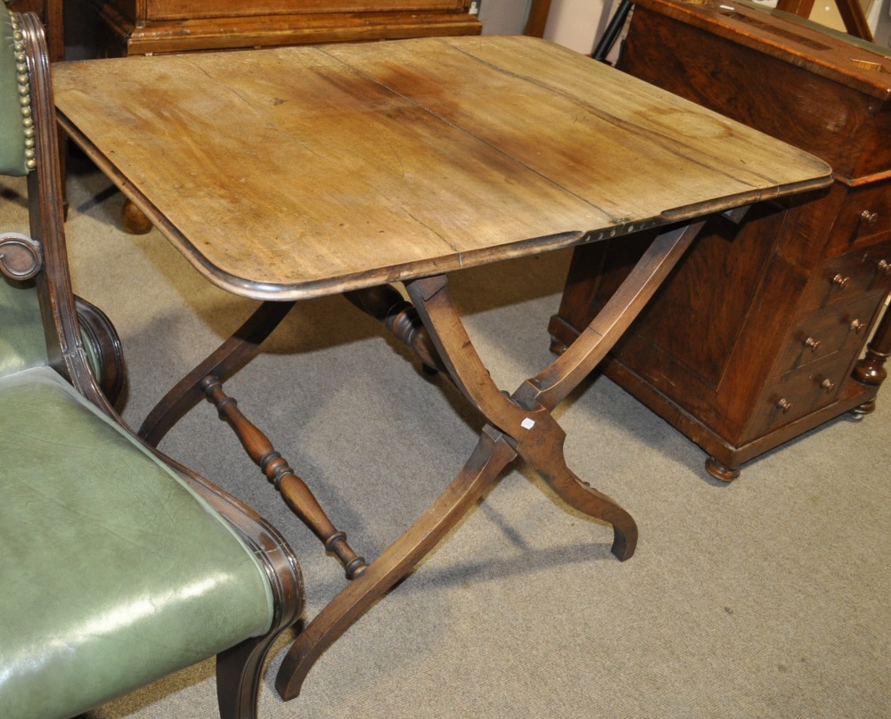 An early 19th century mahogany  coaching table with shaped stretchers, width 33".