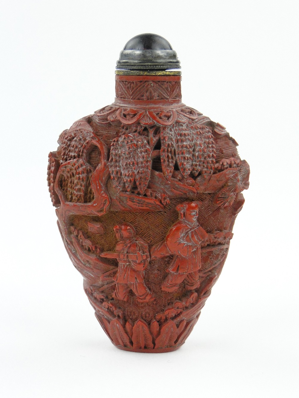 Antique Chinese carved cinnabar snuff bottle with design of figures and trees, with stopper, 2.5".