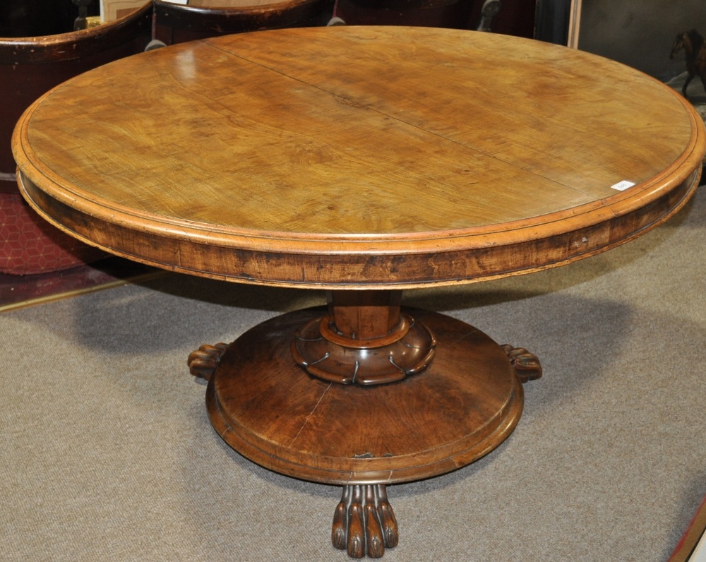 A William IV mahogany circular tilt top breakfast table raised on centre column and platform base