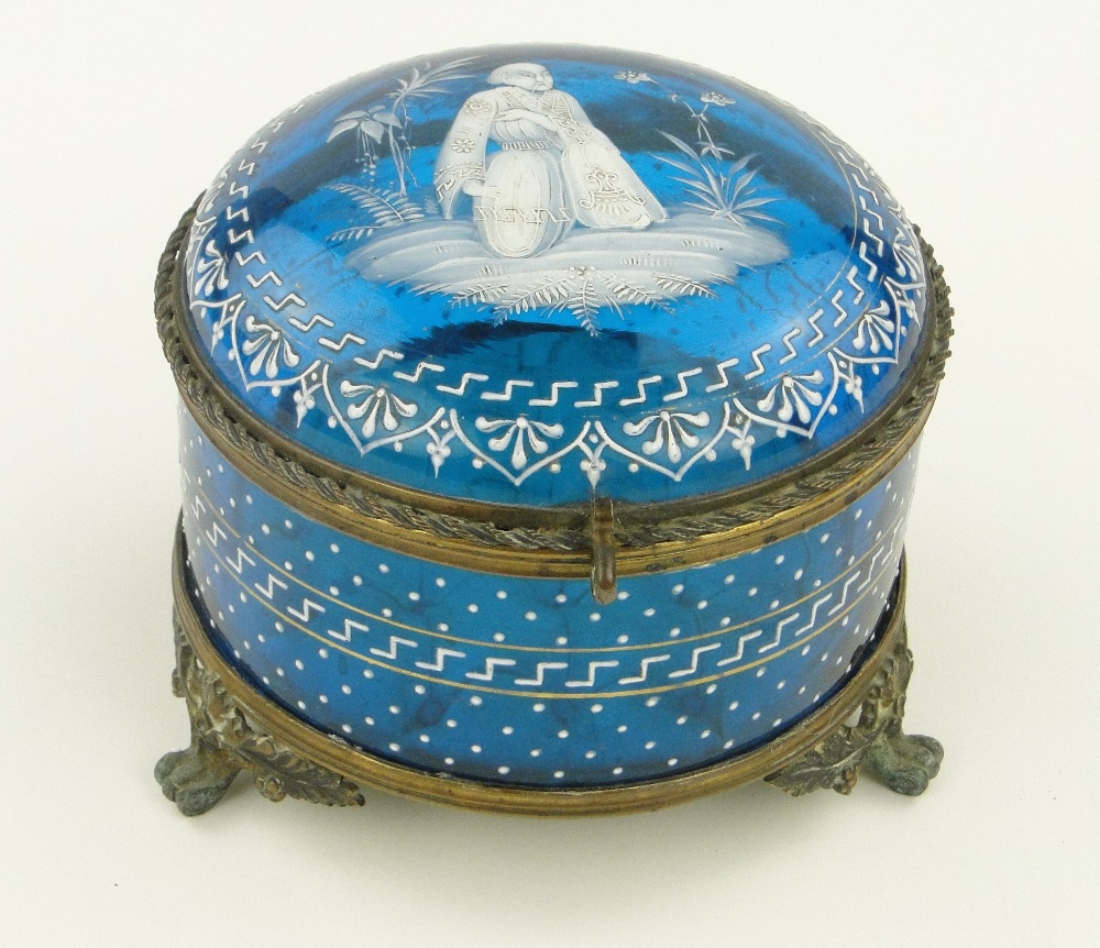 A Victorian Mary Gregory design blue glass casket with gilt metal mounts and buttoned silk interior,