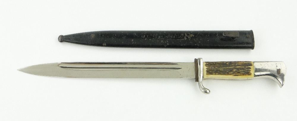 A German Second World War bayonet with horn handle and scabbard and Solingen blade.