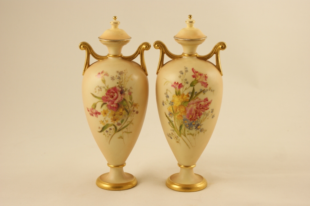 Pair of Royal Worcester peach ground pedestal vases, circa 1906, slender ovoid form with twin