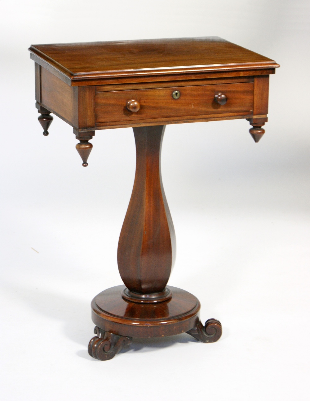 Victorian mahogany pedestal work table, circa 1860, having a swivel folding top over a single