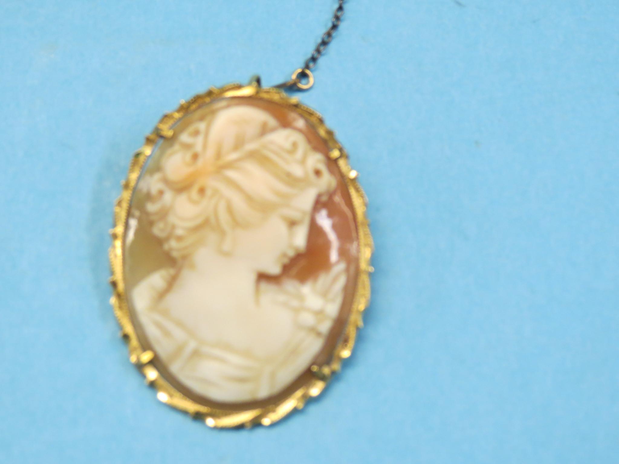 An 18ct. gold cameo brooch, oval-shape carved with portrait bust of a maiden, 1.75in., also to