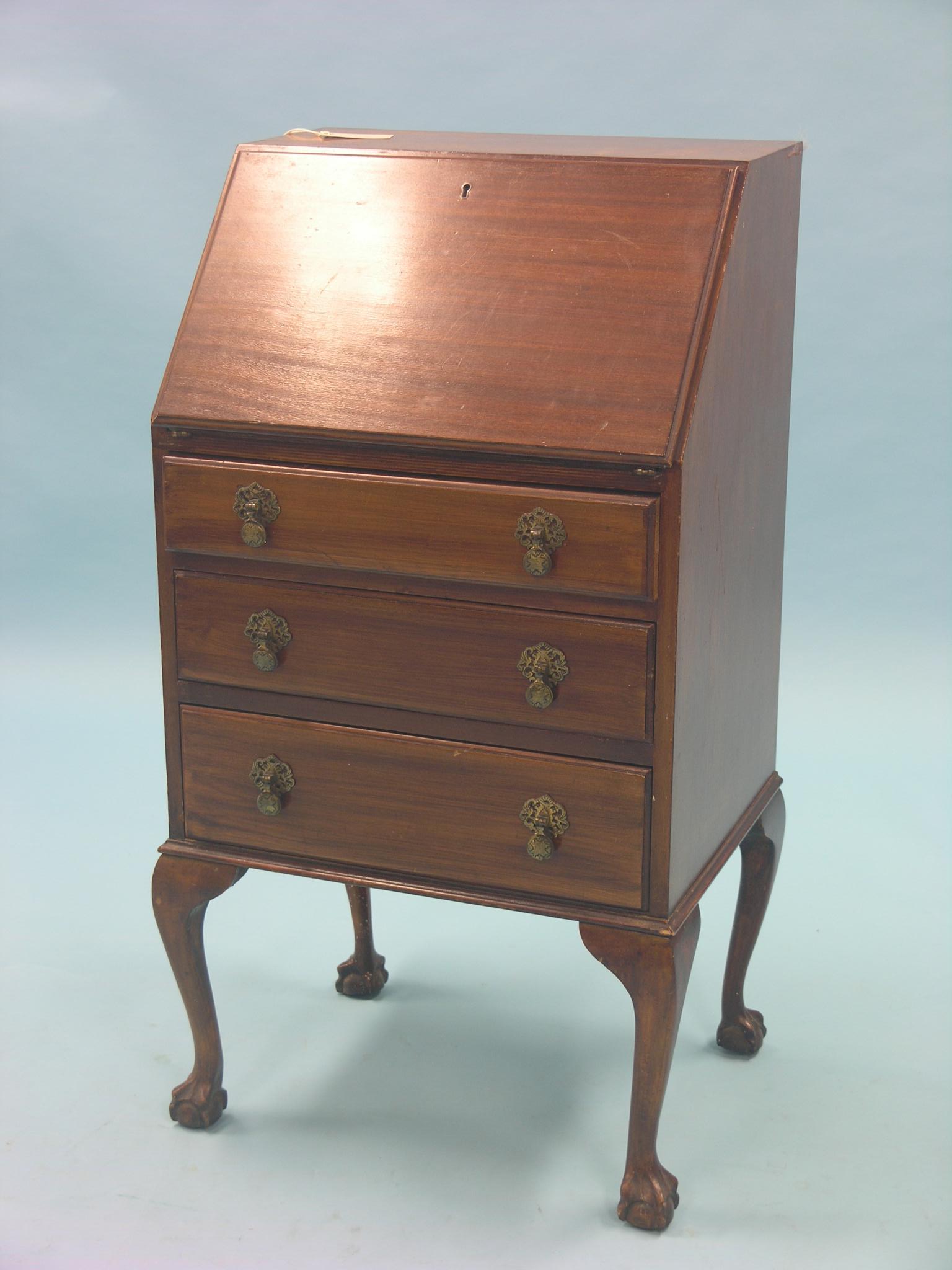 An early 20th century mahogany lady`s bureau, fall-front enclosing fittings above three drawers,