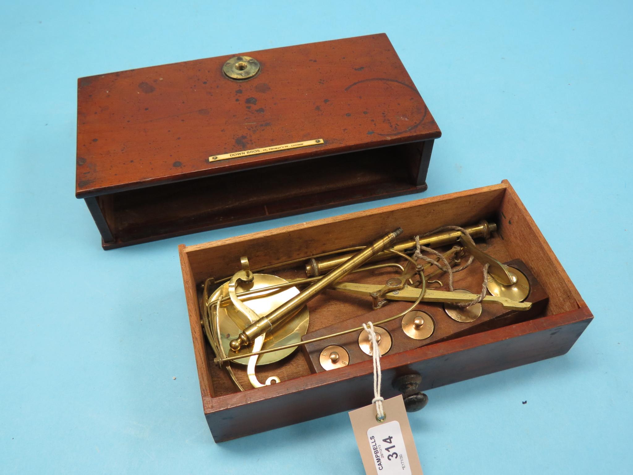 A Victorian mahogany weighing scale, with brass pans, five graduated weights