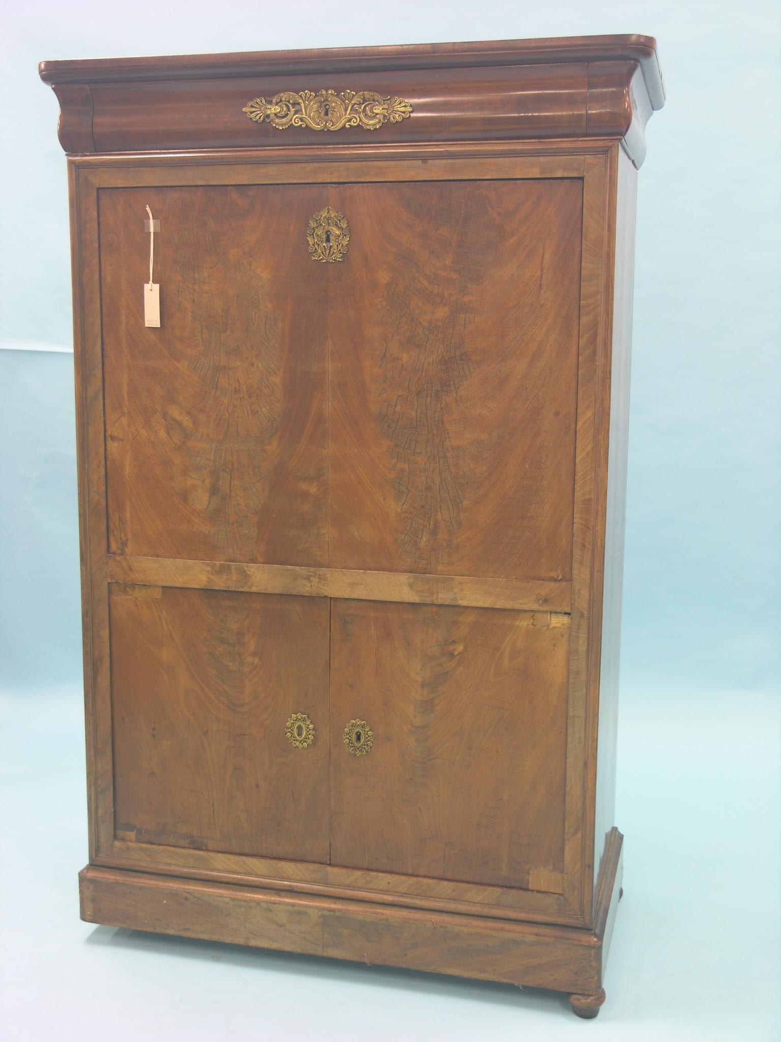 An early 19th century French mahogany secretaire a abattant, ovolo frieze drawer, fall-front