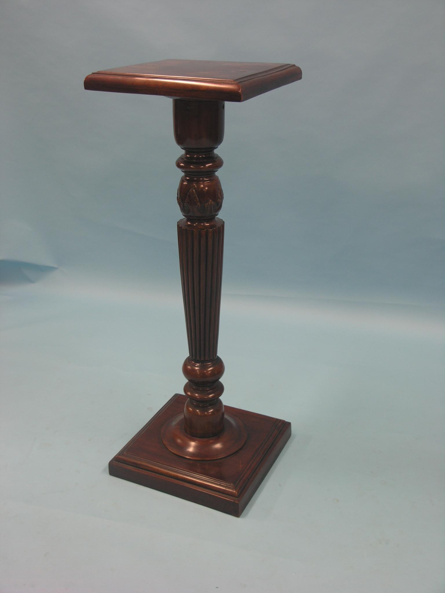 A mahogany torchere, square top on turned and reeded pedestal, 3ft. 3in. high