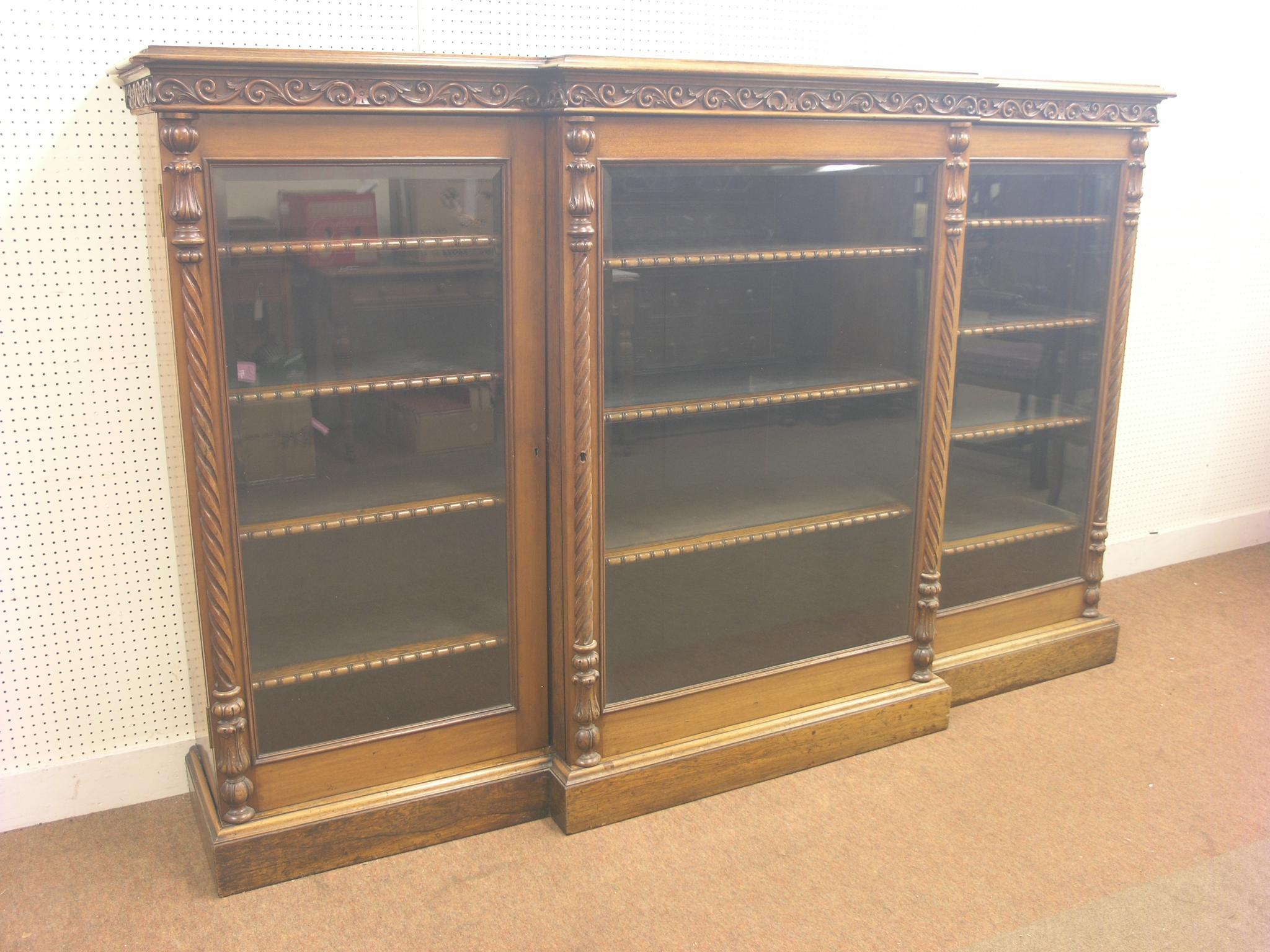 A Victorian rosewood and mahogany break-fronted bookcase, arrangement of eleven adjustable, lined