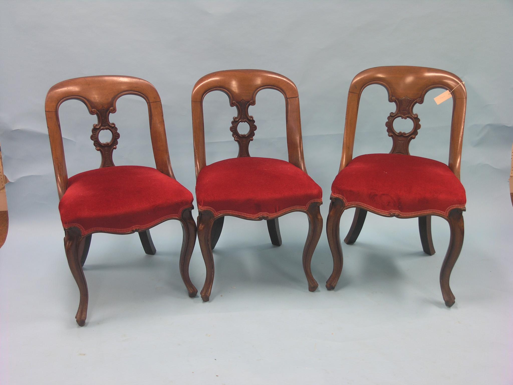 A set of three Victorian mahogany dining chairs, rounded backs with pierced scroll splats,