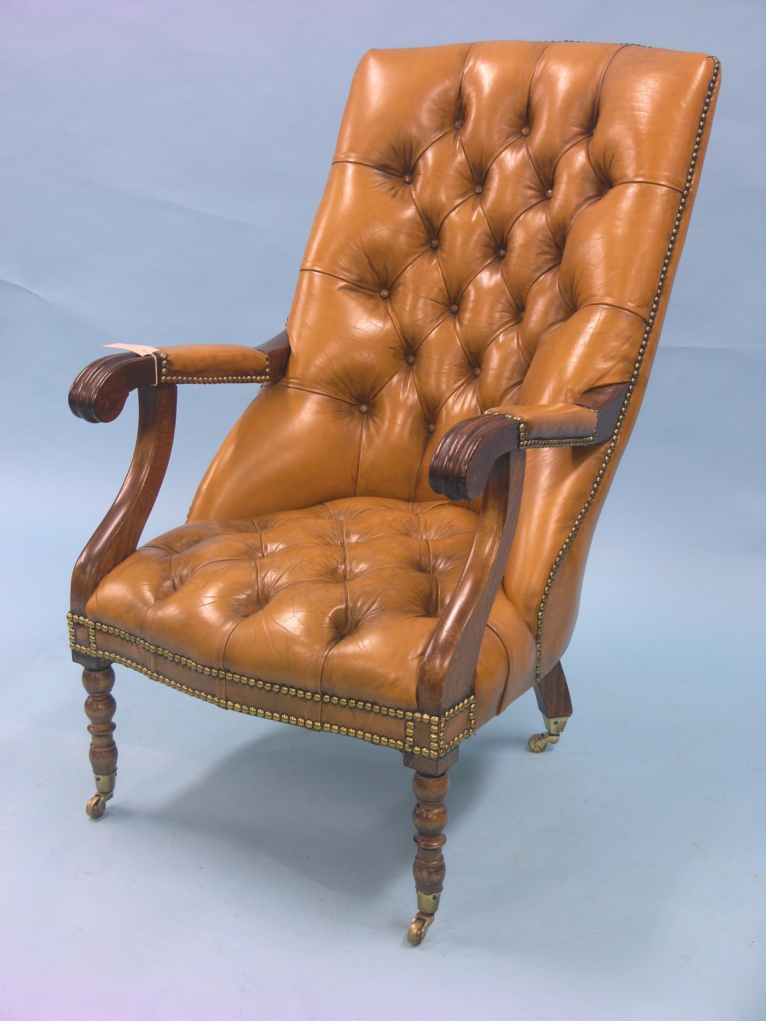 A William IV-style mahogany elbow chair, upholstered in a buttoned olive dralon, on casters
