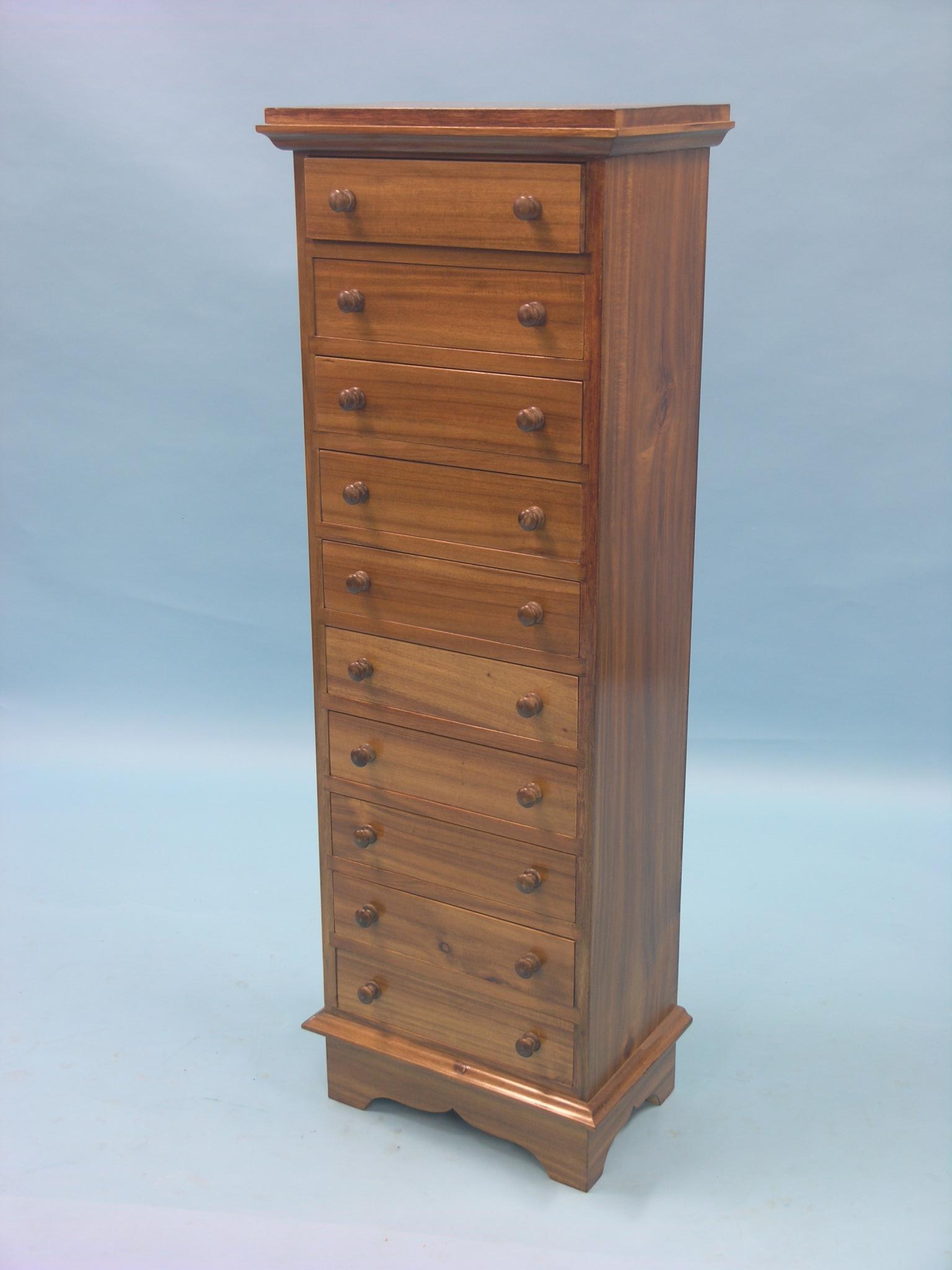 A narrow mahogany chest, ten drawers, each with turned wood knob handles, 16in.