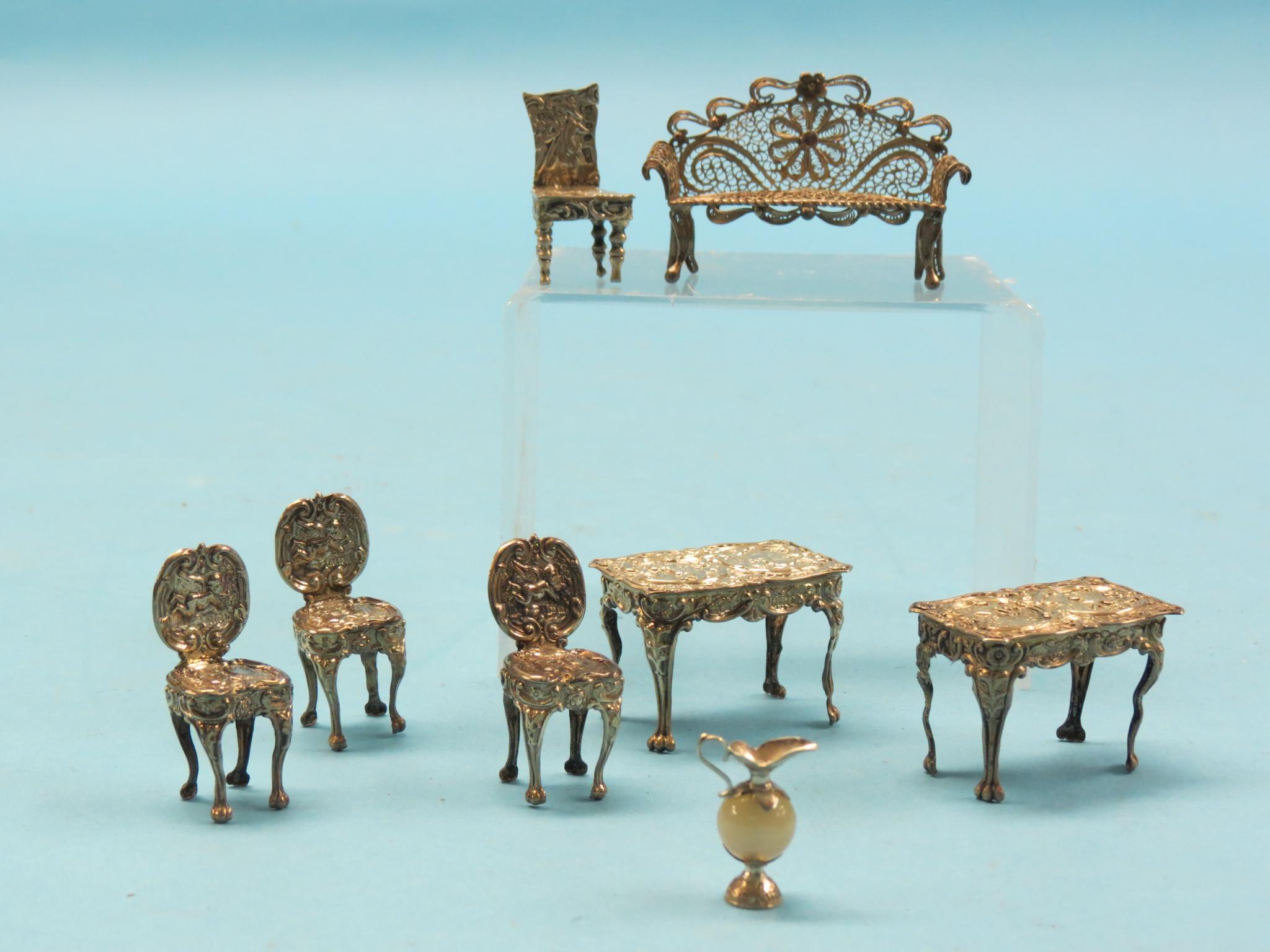 A miniature silver suite of furnishings, pair of tables and set of three dining chairs,