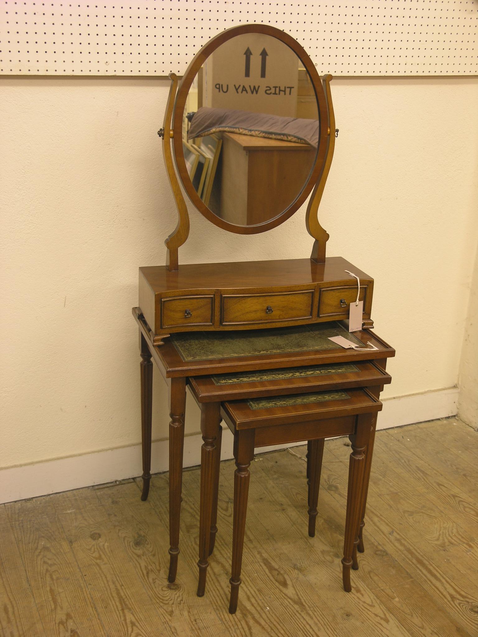 A Georgian-style yew-veneered toilet mirror, 1ft. 8in. and a mahogany nest of three tables