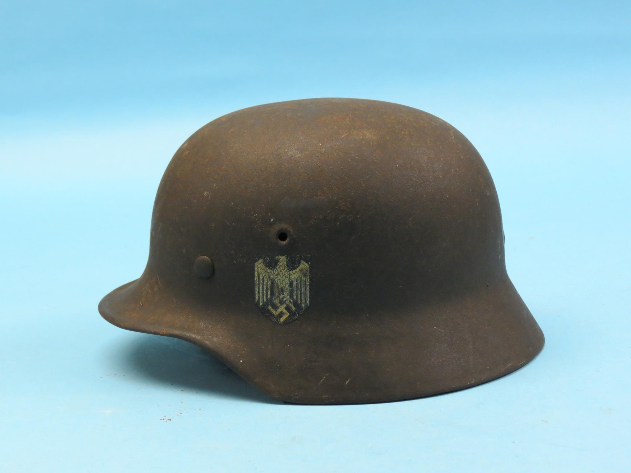 A World War II German Wermacht helmet, named to Lt. Hans Raabe, with full provenance. This helmet