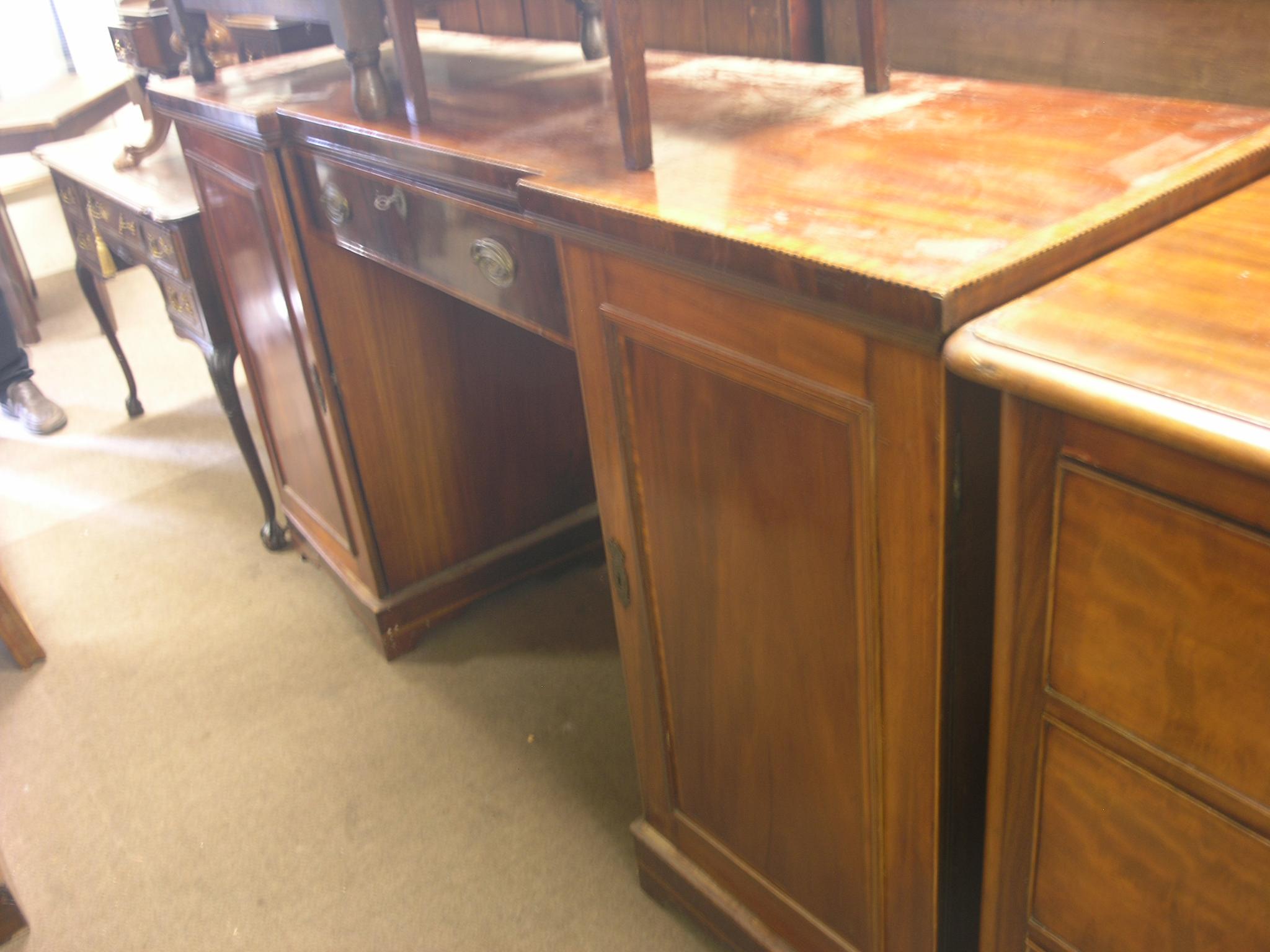 An Edwardian inlaid mahogany sideboard, each pedestal enclosing shelves, single drawer between,