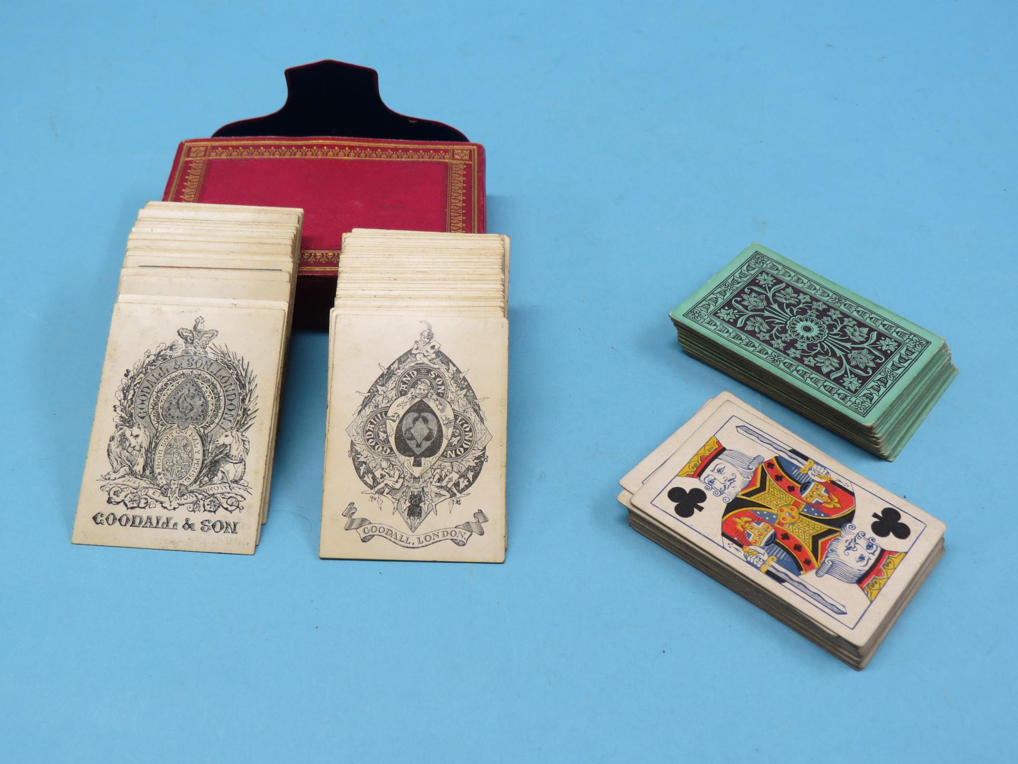 A Victorian twin-set of playing cards, one set gilded with post-1837 Royal Arms, contained within