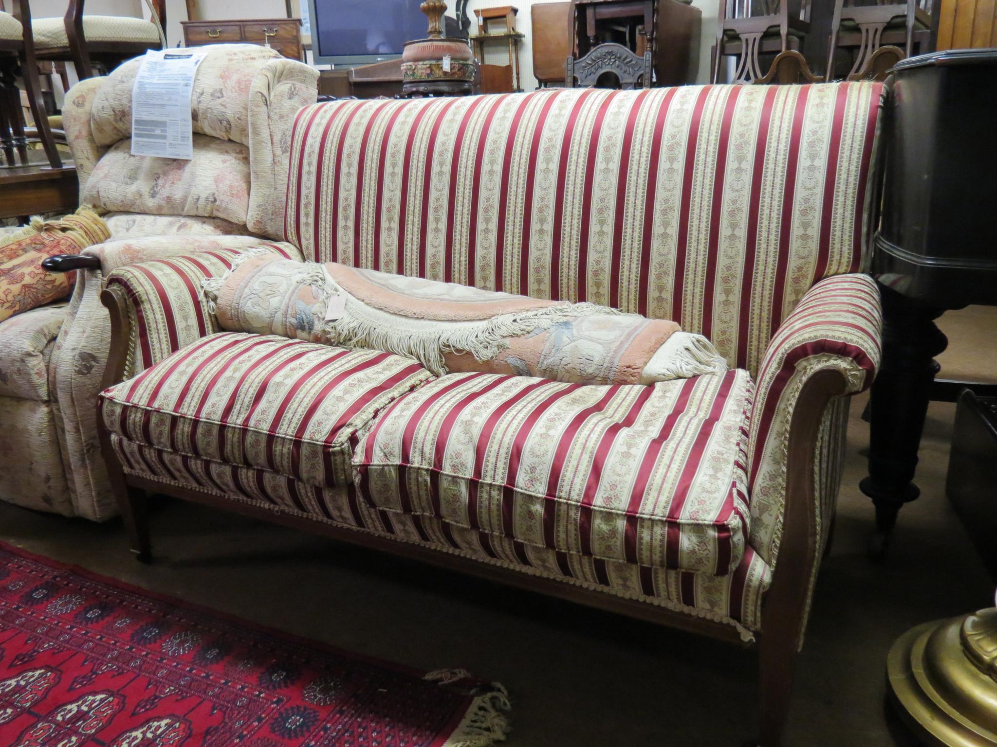 An Edwardian three-piece suite, consisting of two-seater settee and a pair of armchairs, mahogany