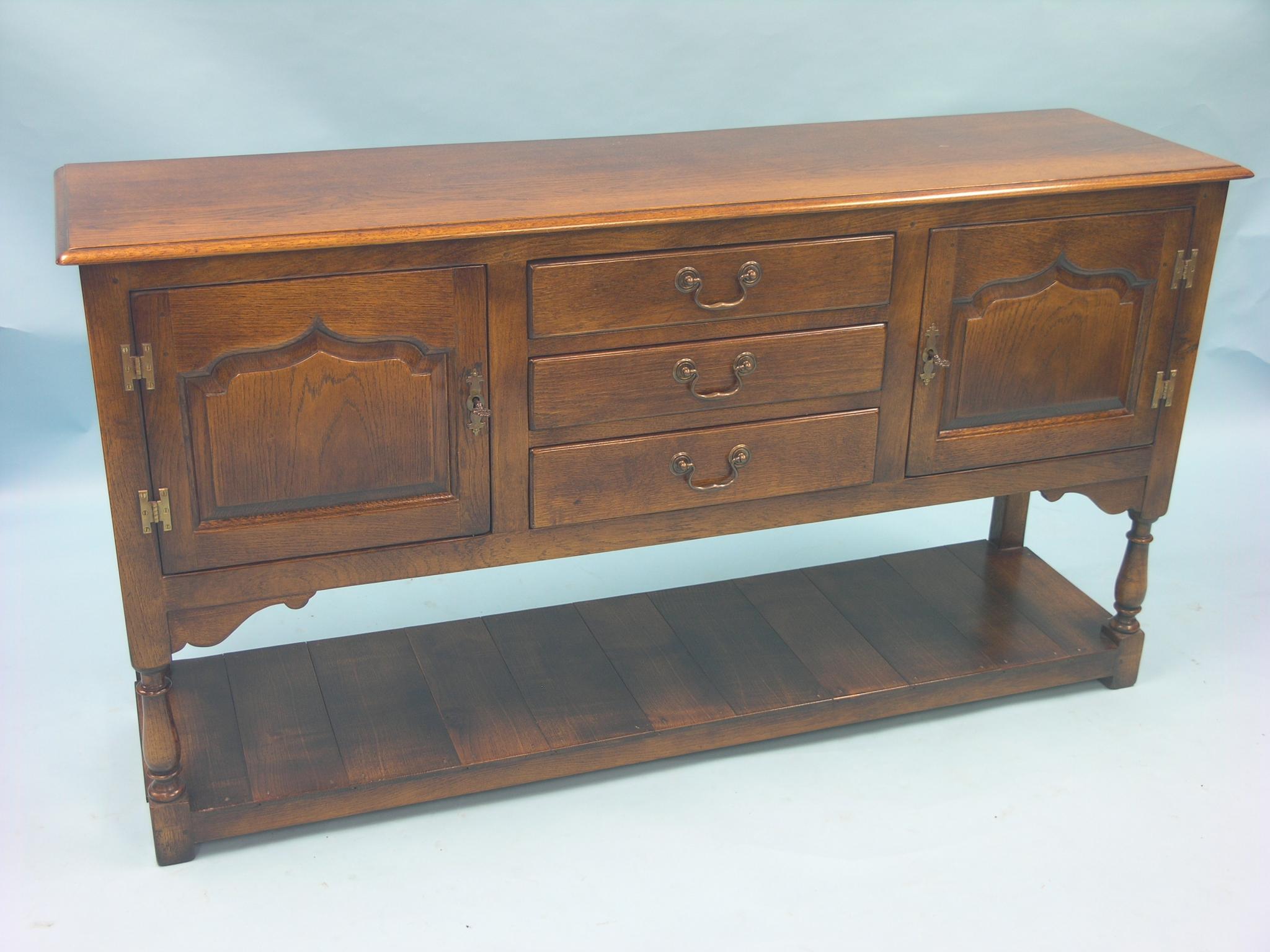 A good quality early 18th century-style oak dresser base, pair of arched and fielded panel