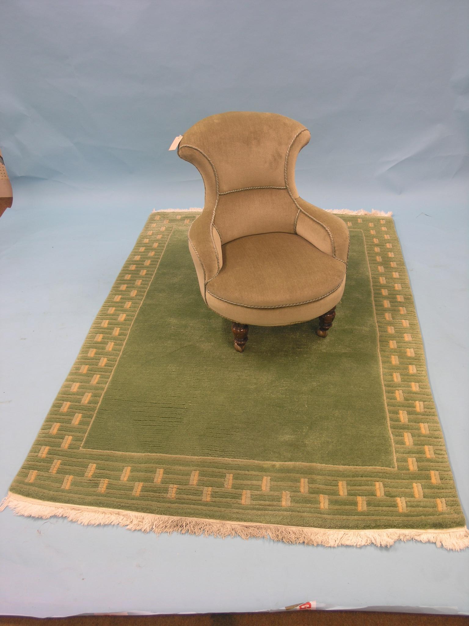 A Victorian nursing elbow chair, upholstered in a pale green dralon, on front turned legs with