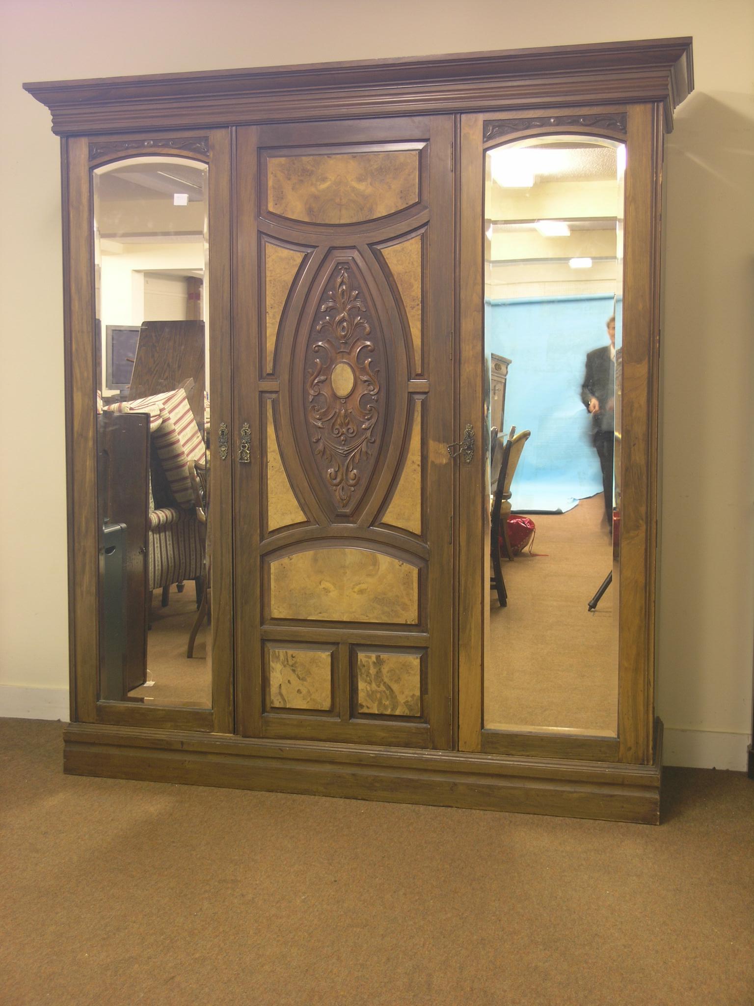 A late Victorian walnut bedroom pair, large wardrobe fitted with sliding trays and drawers, enclosed