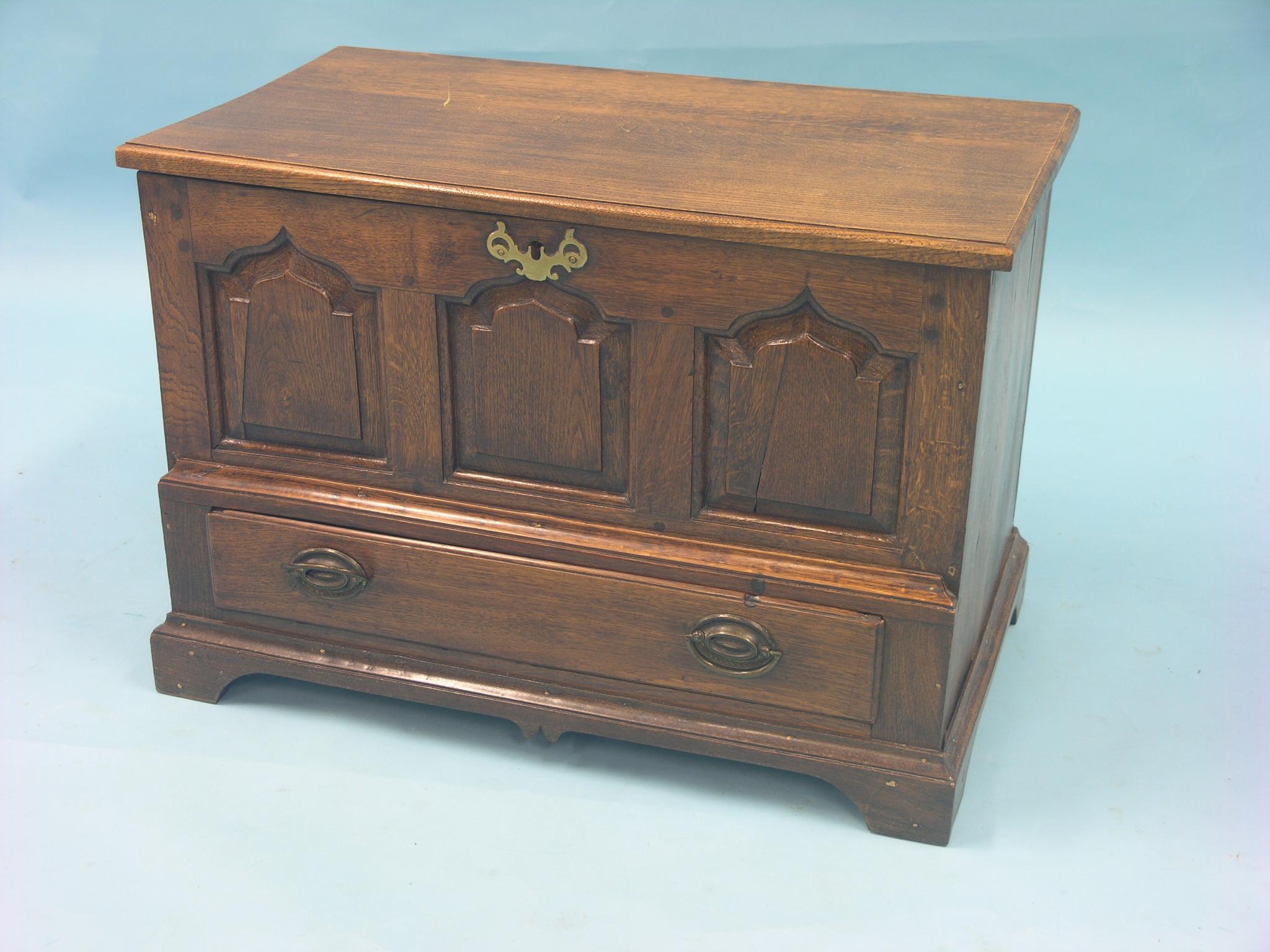 A Georgian-style oak coffer, frontage with fielded and arched panels, detachable top, single