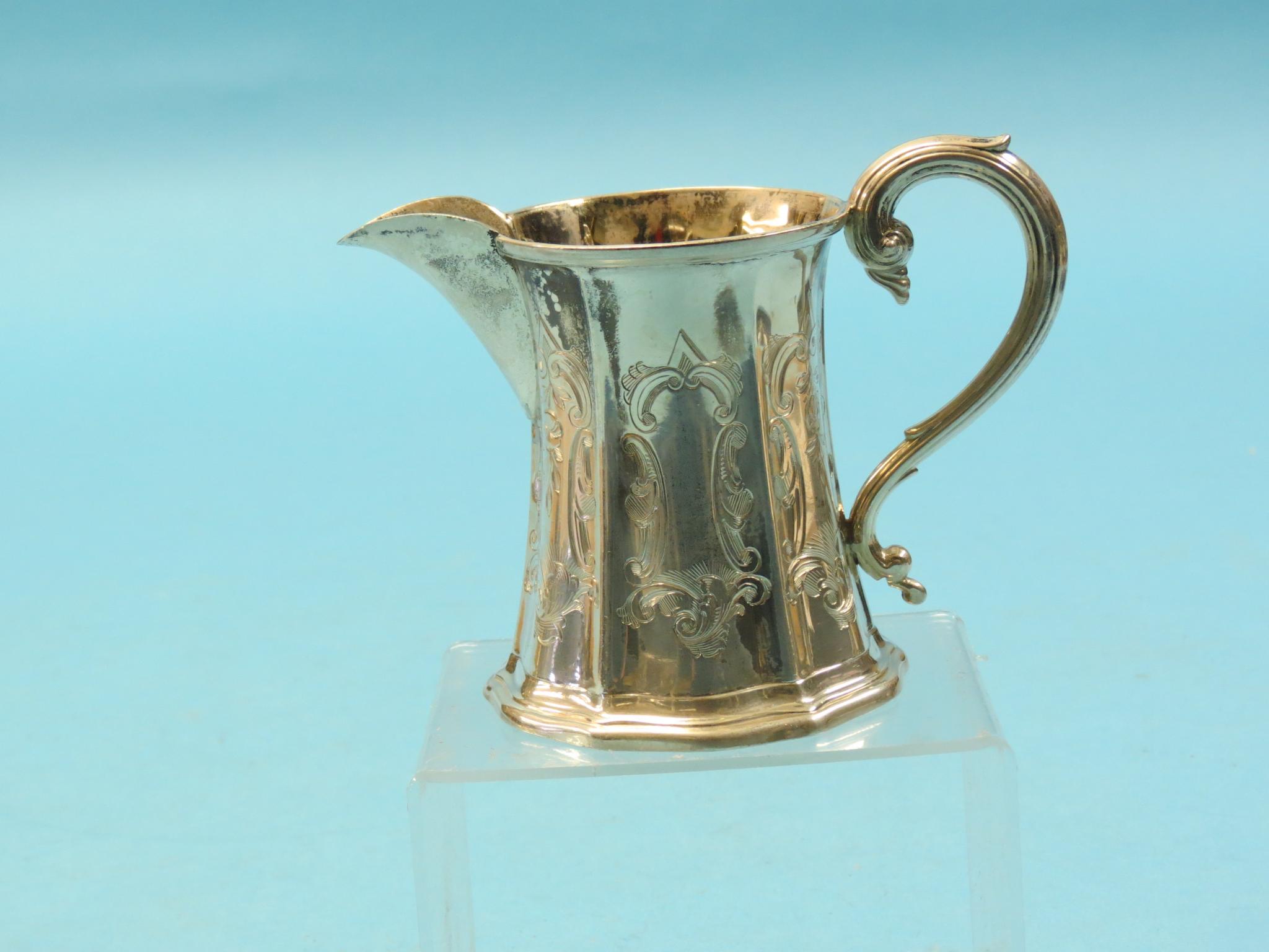 A Victorian silver milk jug, waisted form with engraved detail, scroll handle, Sheffield 1851, 3.