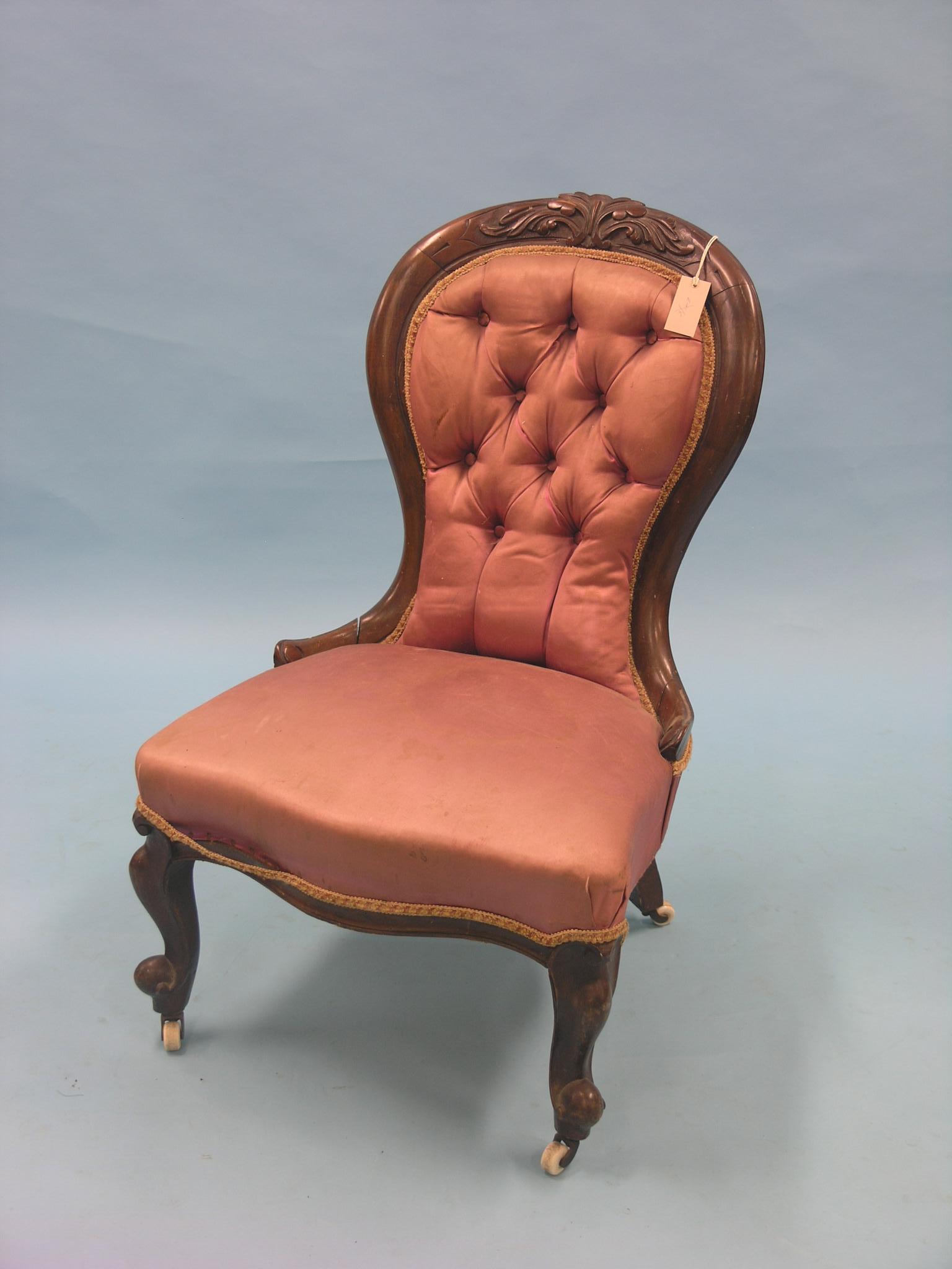A Victorian mahogany-framed drawing room chair, spoon-back on cabriole legs with casters, upholstery
